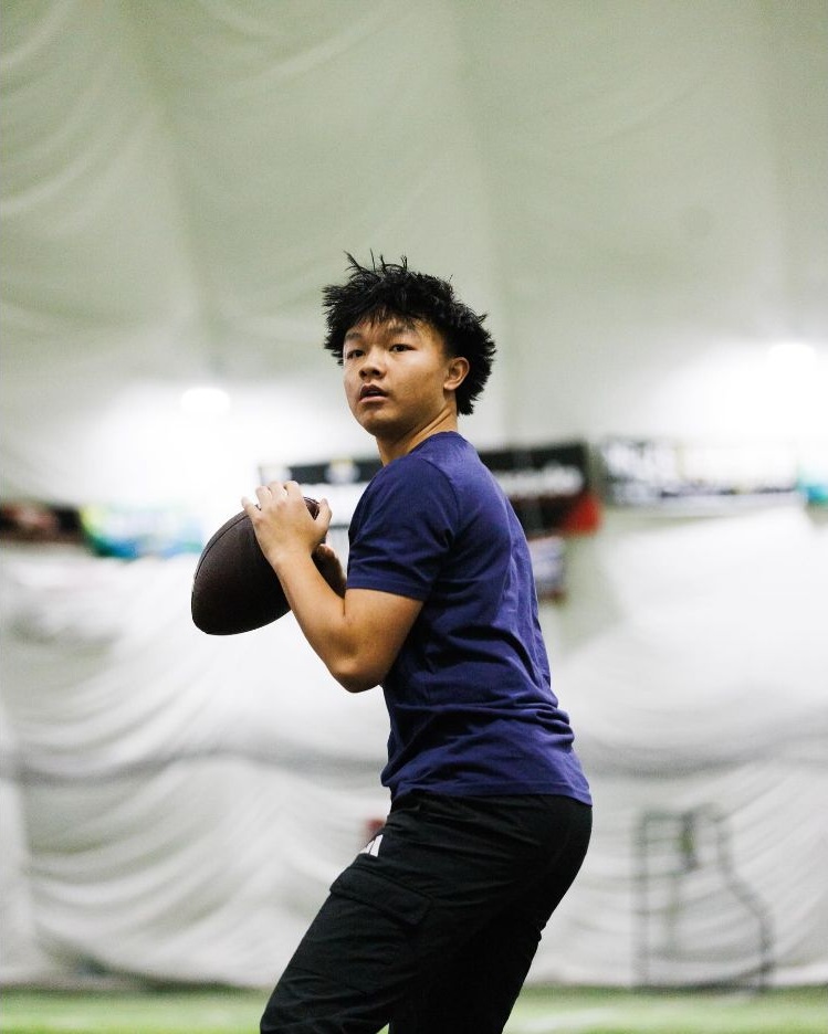 Logan Yang training indoors with a football